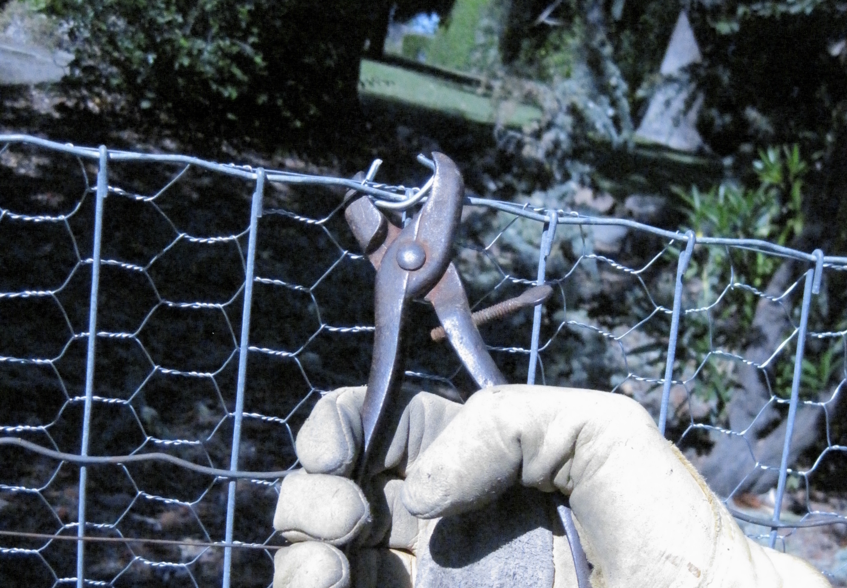 Using Grandpa's hog ring pliers to join fencing